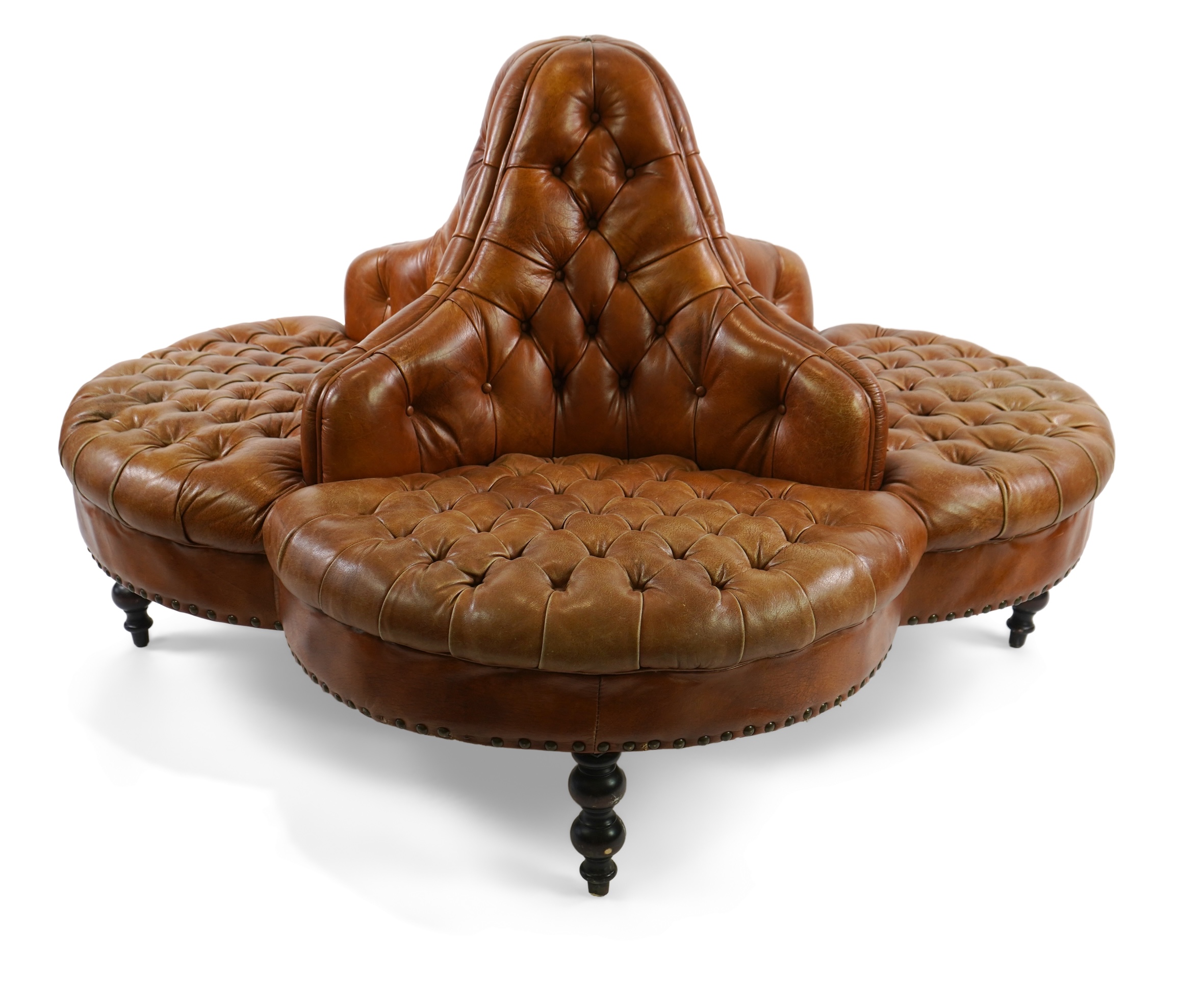 A contemporary Victorian style buttoned tan leather conversation seat